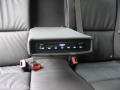 BMW 320d.  Screen installation into headrest with cordless headphone. Single DVD player installed into centre armrest.