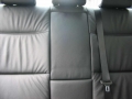 BMW 320d.  Screen installation into headrest with cordless headphone. Single DVD player installed into centre armrest.