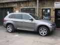 BMW X5. Two Screens fitted to standard active headrest with airbag function undisturbed. 6 Disc DVD changer fitted into boot compartment, remotely controlled.