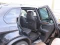BMW X5. Two Screens trimmed into standard headrest. Single DVD player installed into rear of console. Cordless headphones.