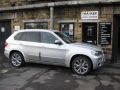 BMW X5. Two Screens fitted to standard active headrest with airbag function undisturbed. Single DVD player fitted into rear of console. Cordless headphone.