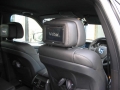 BMW X5. Two Screens fitted to standard active headrest with airbag function undisturbed. Single DVD player fitted into rear of console. Cordless headphone.