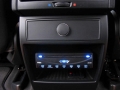 BMW X5. Two Screens trimmed into standard headrest. Single DVD player installed into rear of console. Cordless headphones.