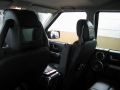 Land Rover Discovery 3. Two screens trimmed into standard headrest. Single DVD player installed into rear on centre console replacing cup holders. Cordless headphones