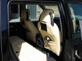 Land Rover Discovery 3. Two screens trimmed into rear of front seats as customer spec. Single DVD player installed into rear on centre console replacing cup holders. Cordless headphones