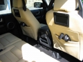 Land Rover Discovery 3. Two screens trimmed into rear of front seats as customer spec. Single DVD player installed into rear on centre console replacing cup holders. Cordless headphones