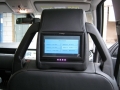 Land Rover Discovery 3. Fitted with screens trimmed into original headrest and 6 disc DVD player installed into standard location in boot area.
