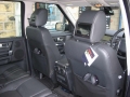 Land Rover Discovery 4. Two screens trimmed into standard headrest. Single DVD player installed into rear on centre console replacing cup holders. Cordless headphones.
