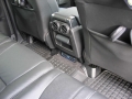 Land Rover Discovery 4. Two screens trimmed into standard headrest. Single DVD player installed into rear on centre console replacing cup holders. Cordless headphones.
