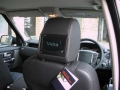 Land Rover Discovery 4. Two screens trimmed into standard headrest. Single DVD player installed into rear on centre console replacing cup holders. Cordless headphones.
