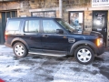 Land Rover Discovery 3. Two screens trimmed into standard headrest. Single DVD player installed into rear on centre console replacing cup holders. Cordless headphones