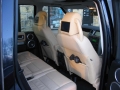 Land Rover Discovery 3. Two screens trimmed into standard headrest. Single DVD player installed into rear on centre console replacing cup holders. Cordless headphones