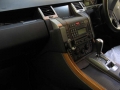 Range Rover Sport. Dension iPod kit and trimmed console fitted to left of centre console. iPod charged through kit, and Audio played through Aux channel on standard hifi.