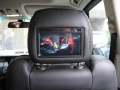 Range Rover Vogue. Two Screens trimmed into headrests. 6 disc disc DVD player installed into boot compartment in standard location. Sony Playstation 2 installed into compartment for factory DVD Changer (not fitted) .Cordless Headphones.