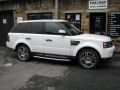 Range Rover Sport 2010. Screens trimmed into original headrests. 6 Disc DVD changer install to standard location. Cordless Headphones.