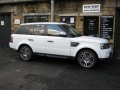 Range Rover Sport 2010. Screens trimmed into original headrests. 6 Disc DVD changer install to standard location. Slimline Sony PS3 console installed in boot. Cordless Headphones.
