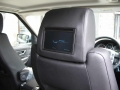 Range Rover Sport. Two Screens trimmed into headrests. Single disc DVD player installed into rear of centre console. Sony Playstation 2 installed into compartment for factory DVD Changer (not fitted) .Cordless Headphones.