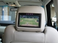 Range Rover Vouge 2010. Screens trimmed into original headrests. 6 Disc DVD changer install to standard location. Facory installed Digital TV image wired to rear headrest screens Cordless Headphones.