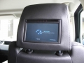Range Rover Sport. Two Screens trimmed into headrests. Single disc DVD player installed into rear of centre console. Sony Playstation 2 installed into compartment for factory DVD Changer (not fitted) .Cordless Headphones.